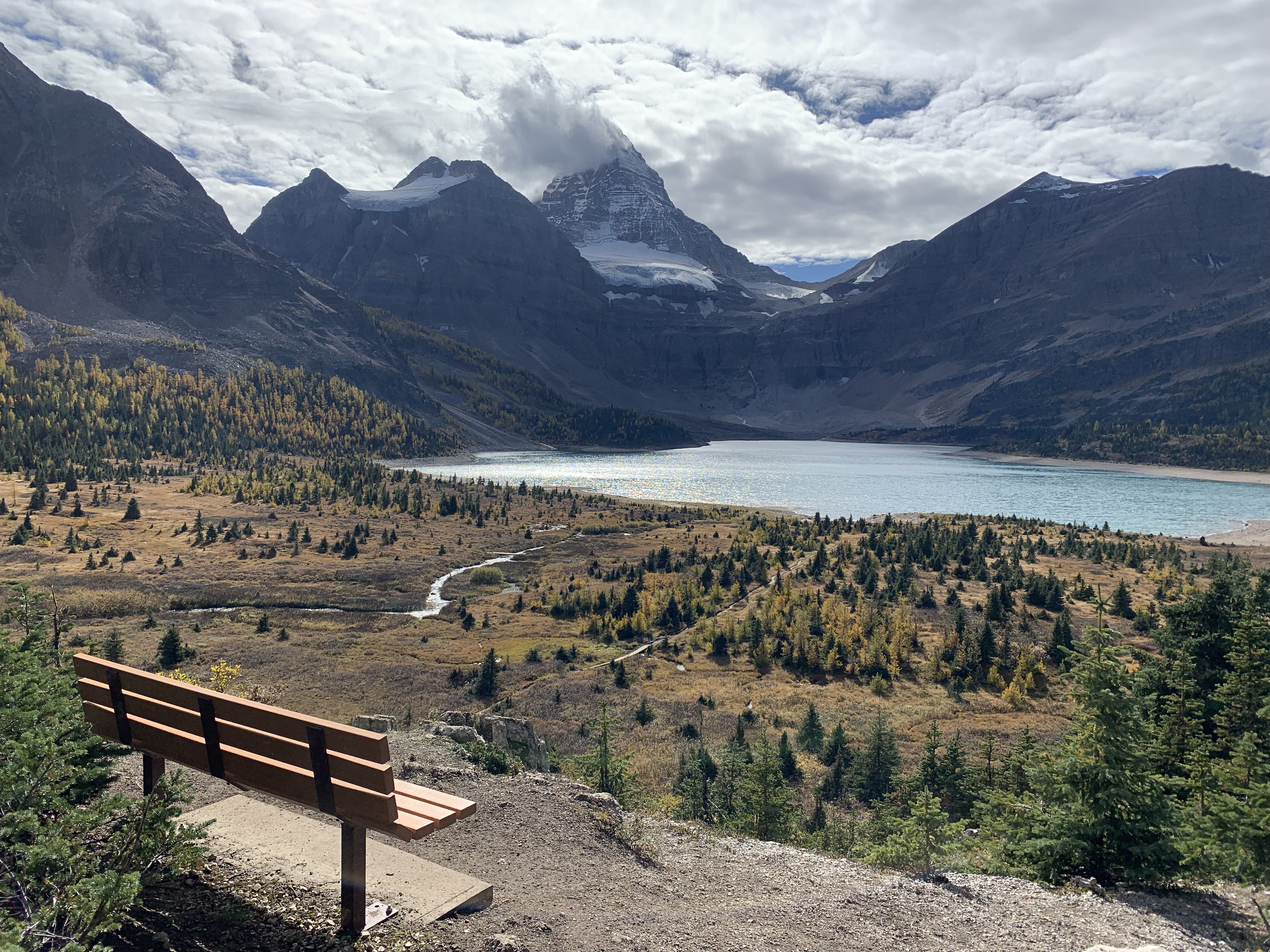 A bench overlooking Lake Magog and Mount Assiniboine