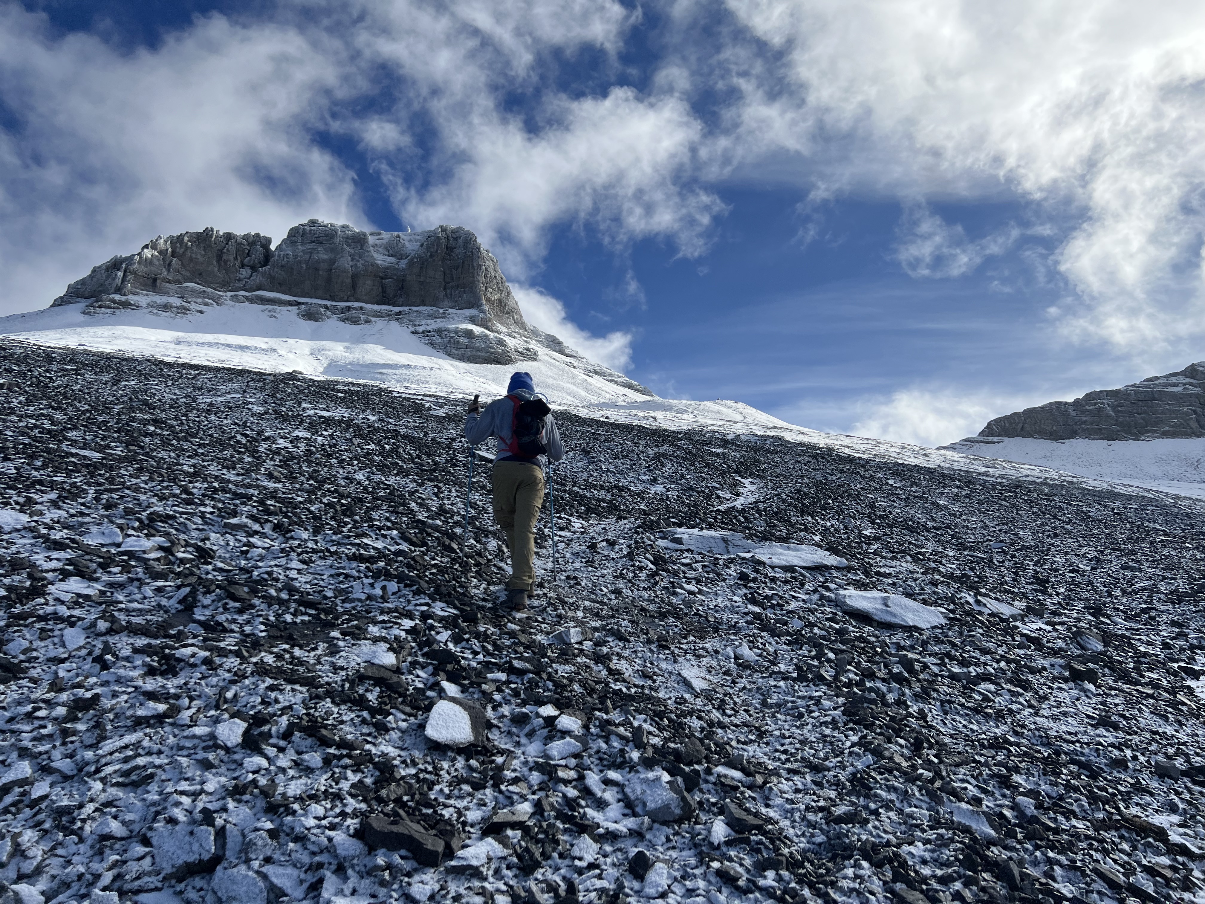 Jesse heading up the snowy scree slopes below the Mount Sparrowhawk summit block