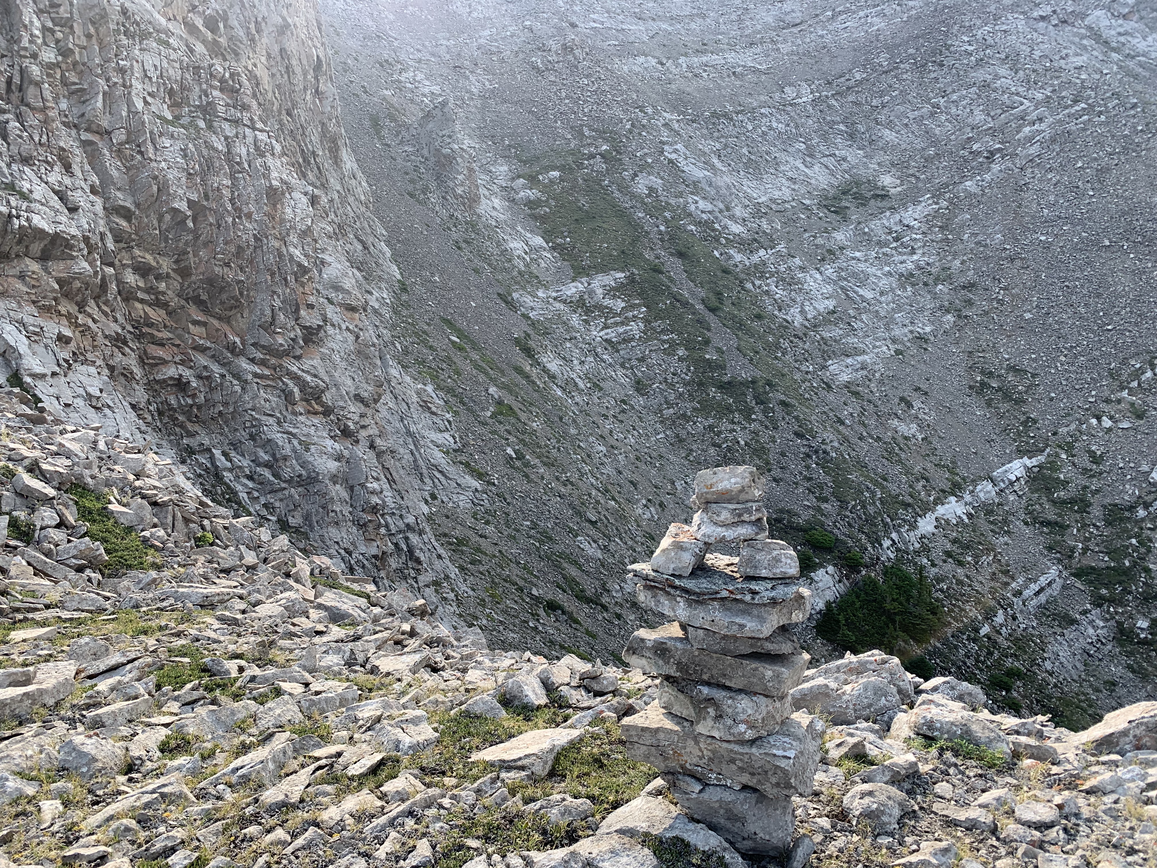 We got so extremely lucky that the ledge that we chose was the correct one. It is the only big break in the cliff band visible at left. We built a huge cairn so we could find our way back (it wasn’t really needed though since this part is quite obvious. From here, we followed the obvious trend of the day which is to traverse and ascend the giant bowl ahead. Also, the bowl looks big but really isn’t, it took probably no more than 15 minutes to cross. We dropped down, then ascended the grassy section and traversed on a scree ledge at the top of the photo.