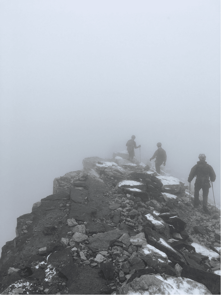 Jesse on the summit of Mount Temple, his view clouded by fog